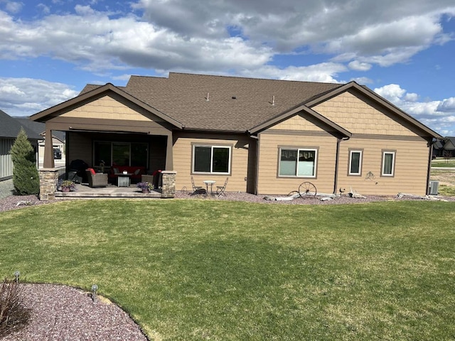 2669 Bunkhouse Pl, Missoula, MT 59808 - back of property featuring a lawn, a patio area, a shingled roof, and central AC