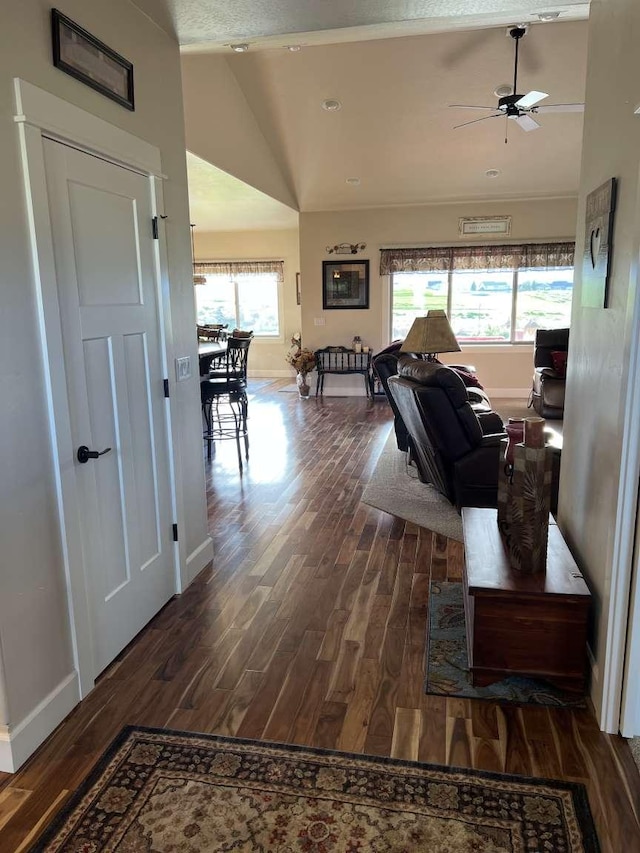 2669 Bunkhouse Pl, Missoula, MT 59808 - living room featuring wood finished floors, vaulted ceiling, and baseboards