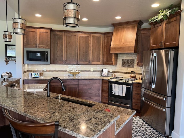 2669 Bunkhouse Pl, Missoula, MT 59808 - kitchen featuring freestanding refrigerator, black microwave, gas range oven, premium range hood, and a sink