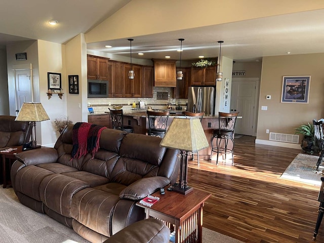 2669 Bunkhouse Pl, Missoula, MT 59808 - living area featuring dark wood-type flooring, baseboards, lofted ceiling, and recessed lighting