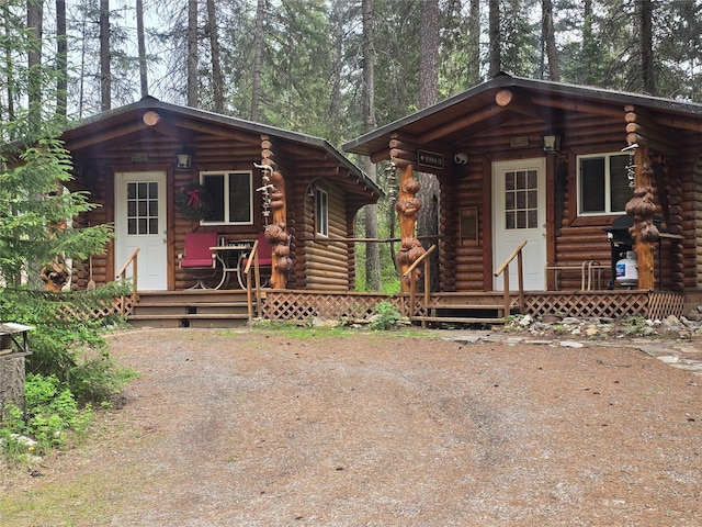 204 Cougar Meadow Dr, Saint Regis, MT 59866 - cabin with log exterior and a porch