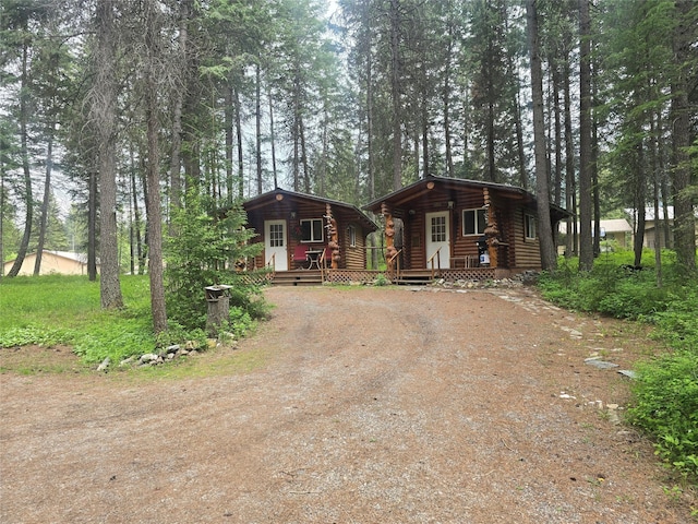 204 Cougar Meadow Dr, Saint Regis, MT 59866 - cabin with driveway, log exterior, and covered porch