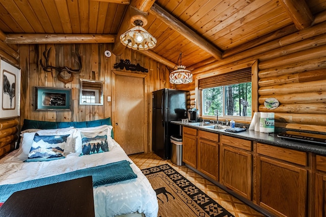 204 Cougar Meadow Dr, Saint Regis, MT 59866 - kitchen with freestanding refrigerator, a sink, wood ceiling, brown cabinets, and log walls