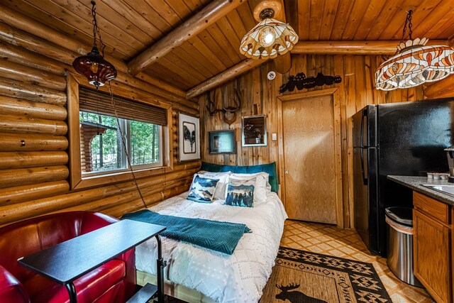 204 Cougar Meadow Dr, Saint Regis, MT 59866 - bedroom featuring wood ceiling, rustic walls, and freestanding refrigerator