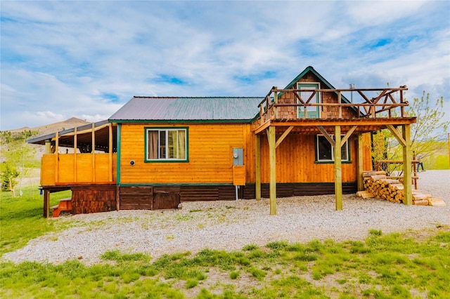 34 Outlaw Trl, Anaconda, MT 59711 - view of front of house with metal roof and a wooden deck