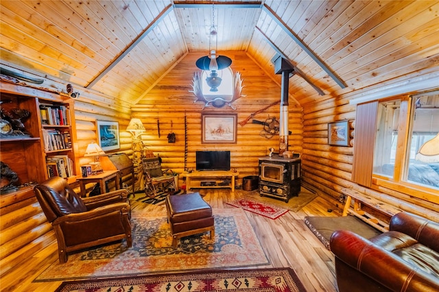 34 Outlaw Trl, Anaconda, MT 59711 - living room featuring wood ceiling, lofted ceiling, a wood stove, log walls, and wood-type flooring