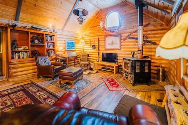 34 Outlaw Trl, Anaconda, MT 59711 - living area featuring a wood stove, wood ceiling, rustic walls, hardwood / wood-style floors, and high vaulted ceiling