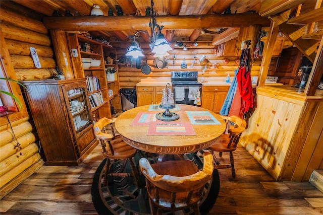 34 Outlaw Trl, Anaconda, MT 59711 - dining room with rustic walls, dark wood-type flooring, wood ceiling with exposed beams, and a chandelier