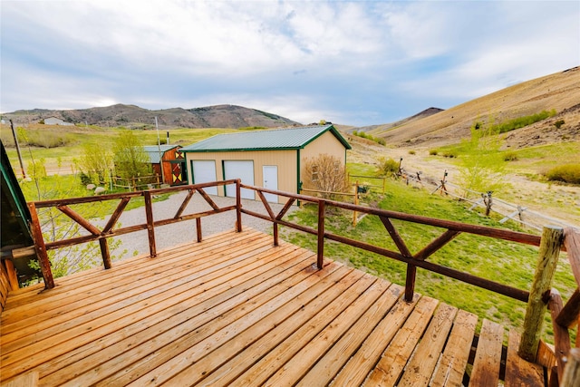 34 Outlaw Trl, Anaconda, MT 59711 - deck featuring a garage, an outbuilding, a mountain view, and a view of rural / pastoral area