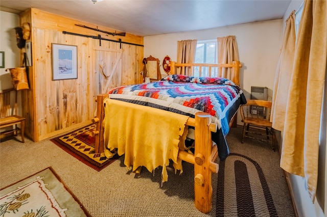34 Outlaw Trl, Anaconda, MT 59711 - carpeted bedroom with wood walls, a barn door, and baseboards