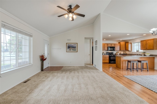 115 River Glen Ct, Kalispell, MT 59901 - unfurnished living room featuring baseboards, a ceiling fan, a chandelier, high vaulted ceiling, and recessed lighting