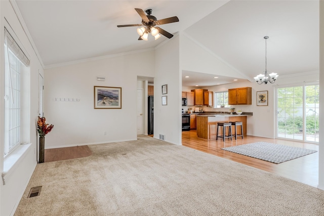 115 River Glen Ct, Kalispell, MT 59901 - living area with a chandelier, ceiling fan, light carpet, baseboards, and crown molding