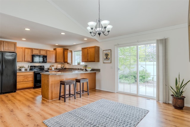115 River Glen Ct, Kalispell, MT 59901 - kitchen featuring black appliances, ornamental molding, brown cabinetry, a chandelier, and vaulted ceiling