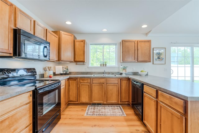 115 River Glen Ct, Kalispell, MT 59901 - kitchen with black appliances, a peninsula, plenty of natural light, light wood-type flooring, and recessed lighting