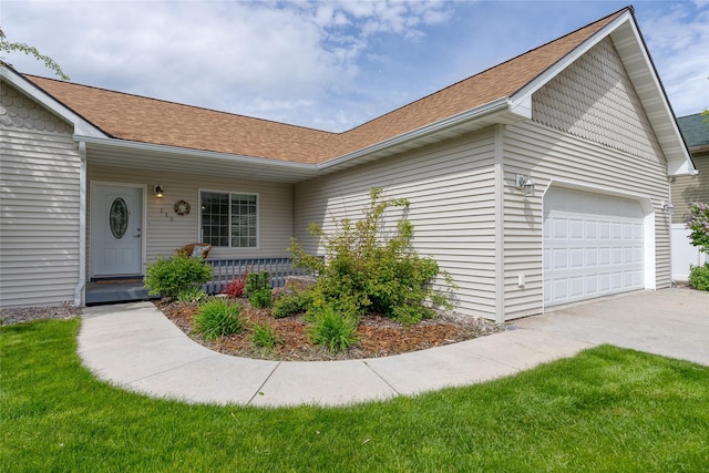 115 River Glen Ct, Kalispell, MT 59901 - view of front of property with a garage, concrete driveway, a shingled roof, and covered porch