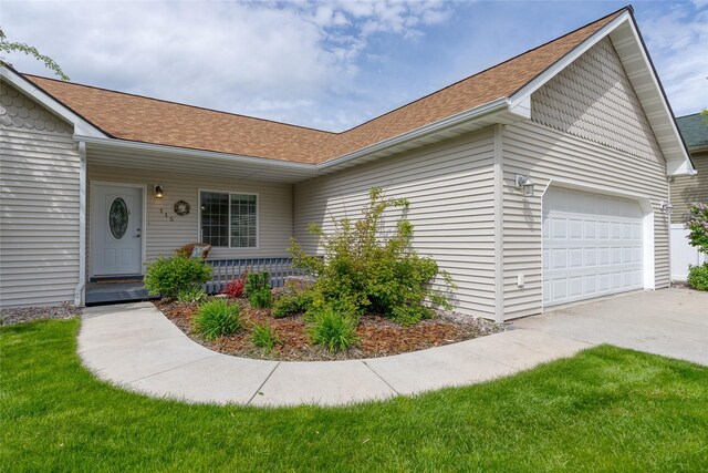 115 River Glen Ct, Kalispell, MT 59901 - view of front facade with an attached garage, concrete driveway, roof with shingles, and covered porch
