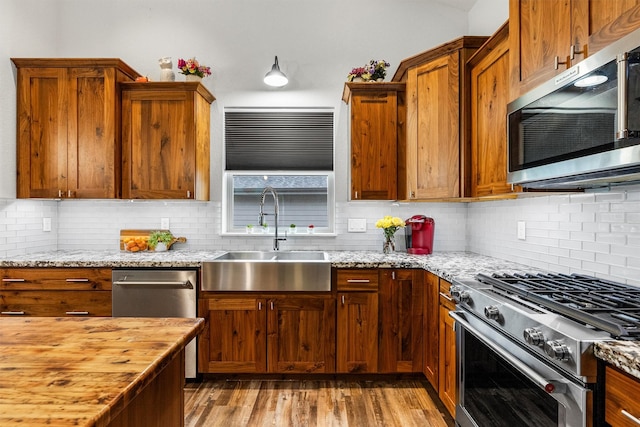 11515 Ninebark Way, Missoula, MT 59802 - kitchen featuring stainless steel appliances, a sink, wood counters, and tasteful backsplash