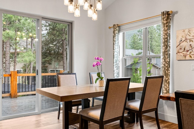 11515 Ninebark Way, Missoula, MT 59802 - dining space with light wood finished floors, a chandelier, and vaulted ceiling