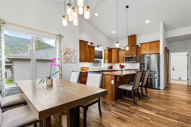 11515 Ninebark Way, Missoula, MT 59802 - dining room with high vaulted ceiling, wood finished floors, a chandelier, and recessed lighting
