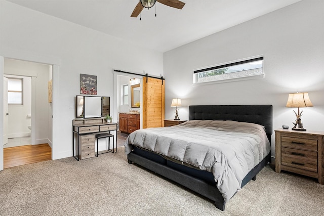 11515 Ninebark Way, Missoula, MT 59802 - bedroom with carpet floors, ensuite bathroom, multiple windows, and a barn door