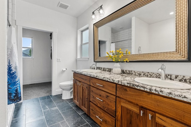 11515 Ninebark Way, Missoula, MT 59802 - full bathroom featuring double vanity, toilet, baseboards, and a shower with curtain