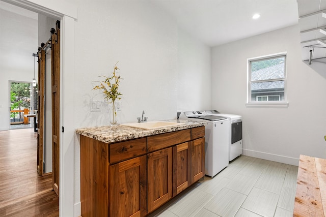 11515 Ninebark Way, Missoula, MT 59802 - laundry room featuring separate washer and dryer, a sink, a barn door, baseboards, and recessed lighting