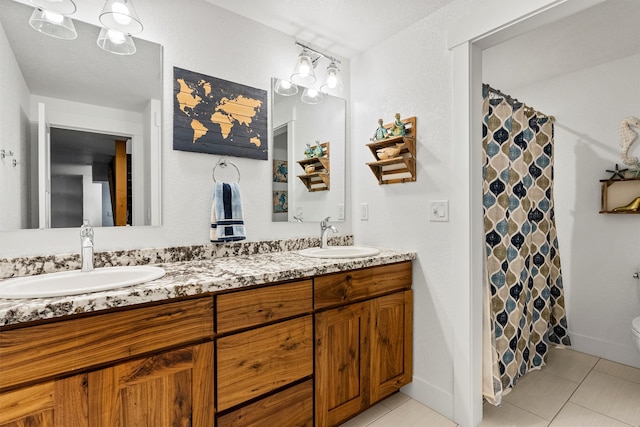 11515 Ninebark Way, Missoula, MT 59802 - full bath with double vanity, toilet, tile patterned flooring, and baseboards