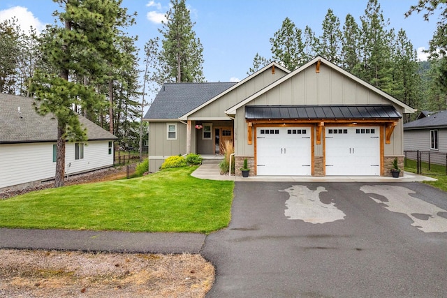 11515 Ninebark Way, Missoula, MT 59802 - view of front of home featuring board and batten siding, an attached garage, a standing seam roof, stone siding, and asphalt driveway