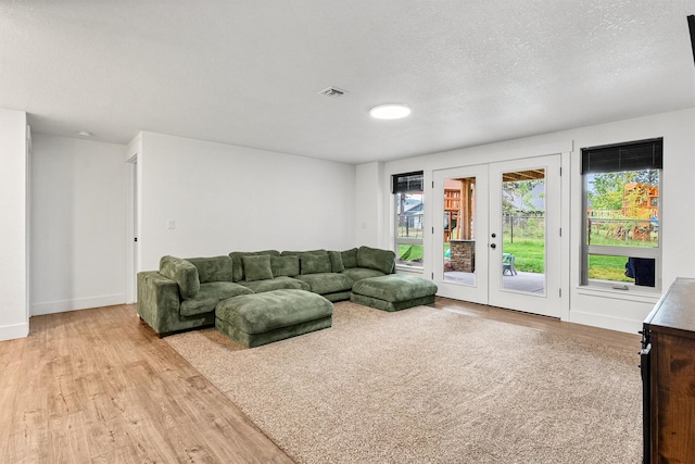 11515 Ninebark Way, Missoula, MT 59802 - living area with french doors, wood finished floors, baseboards, and a textured ceiling