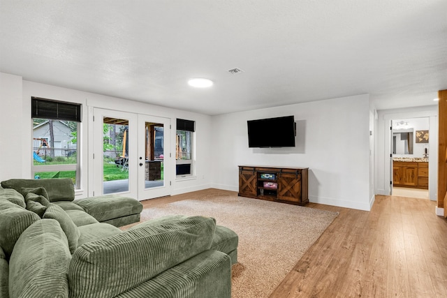 11515 Ninebark Way, Missoula, MT 59802 - living room featuring french doors, light wood finished floors, and baseboards