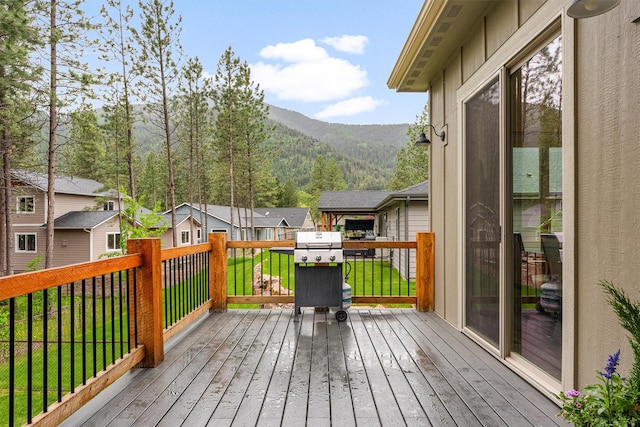 11515 Ninebark Way, Missoula, MT 59802 - wooden deck featuring a mountain view, grilling area, a residential view, and a lawn