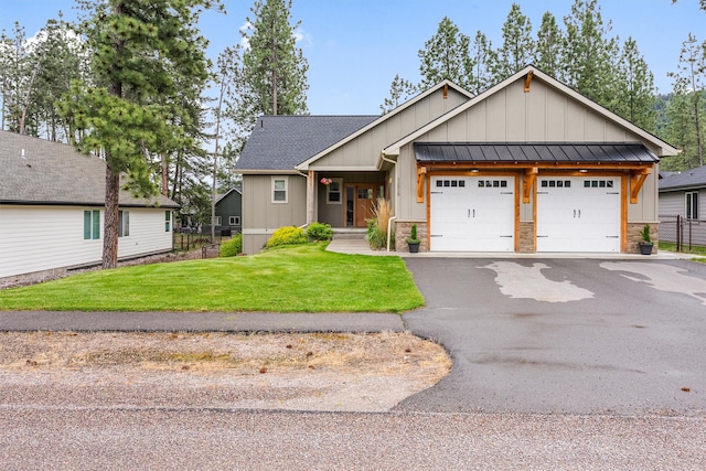 11515 Ninebark Way, Missoula, MT 59802 - view of front of house featuring board and batten siding, a garage, a standing seam roof, and asphalt driveway