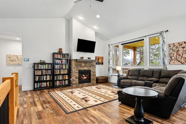 11515 Ninebark Way, Missoula, MT 59802 - living area with a stone fireplace, a ceiling fan, wood finished floors, high vaulted ceiling, and baseboards