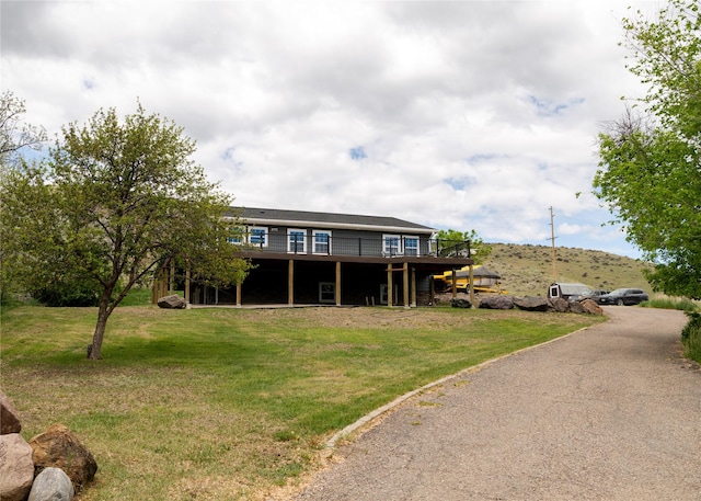 1610 Maple Dr, Fort Benton, MT 59442 - back of house with a deck and a lawn