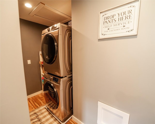 1610 Maple Dr, Fort Benton, MT 59442 - washroom with stacked washer / drying machine, light wood finished floors, baseboards, and attic access