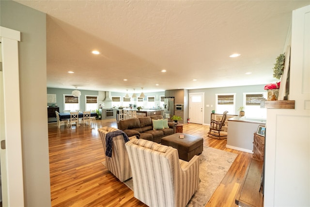 1610 Maple Dr, Fort Benton, MT 59442 - living room with recessed lighting, light wood-style flooring, and a textured ceiling