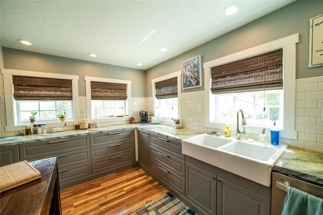1610 Maple Dr, Fort Benton, MT 59442 - kitchen featuring gray cabinets, a sink, stainless steel dishwasher, wood finished floors, and recessed lighting