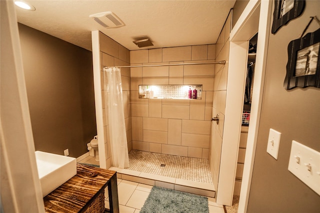 1610 Maple Dr, Fort Benton, MT 59442 - bathroom with a shower stall, toilet, tile patterned flooring, and a textured ceiling