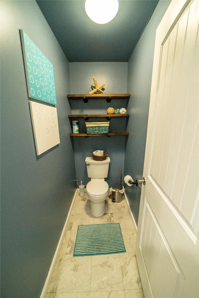 1610 Maple Dr, Fort Benton, MT 59442 - bathroom with marble look tile flooring, baseboards, and toilet