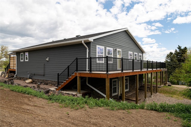 1610 Maple Dr, Fort Benton, MT 59442 - back of property with a wooden deck, stairway, and stone siding