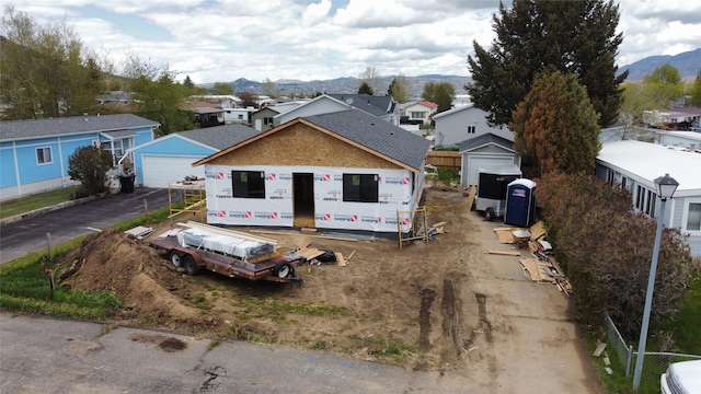 1483 Easy St, Butte, MT 59701 - view of front facade with a detached garage, a residential view, a mountain view, and a shingled roof