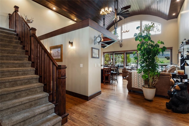 46274 Meadowlark Ln, Big Arm, MT 59910 - staircase with vaulted ceiling, hardwood / wood-style floors, a chandelier, baseboards, and wood ceiling