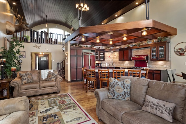46274 Meadowlark Ln, Big Arm, MT 59910 - living area with wood finished floors, stairway, high vaulted ceiling, a chandelier, and wooden ceiling