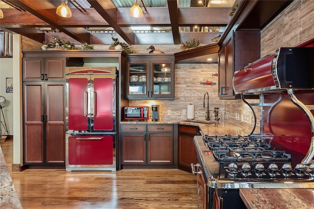 46274 Meadowlark Ln, Big Arm, MT 59910 - indoor wet bar featuring high quality fridge, light wood-style floors, decorative backsplash, beamed ceiling, and coffered ceiling
