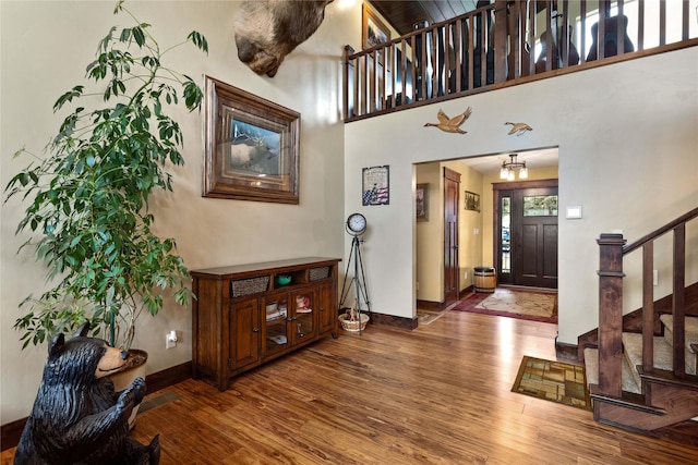 46274 Meadowlark Ln, Big Arm, MT 59910 - entrance foyer with wood finished floors, stairs, and baseboards