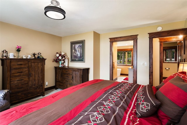 46274 Meadowlark Ln, Big Arm, MT 59910 - carpeted bedroom with baseboards and ensuite bath