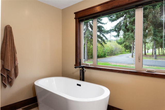 46274 Meadowlark Ln, Big Arm, MT 59910 - bathroom featuring a soaking tub and baseboards