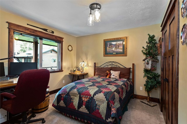 46274 Meadowlark Ln, Big Arm, MT 59910 - bedroom featuring carpet floors, baseboards, and a desk