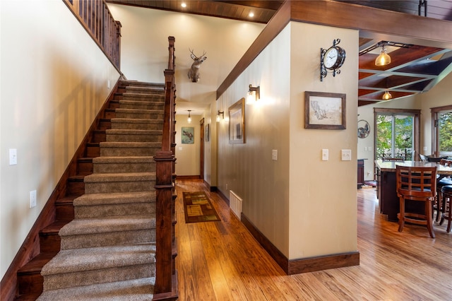 46274 Meadowlark Ln, Big Arm, MT 59910 - stairway with wood finished floors, baseboards, and lofted ceiling