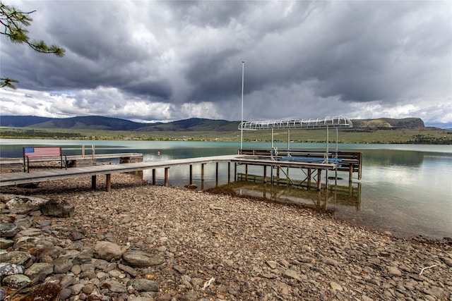 46274 Meadowlark Ln, Big Arm, MT 59910 - dock area featuring a water and mountain view and boat lift